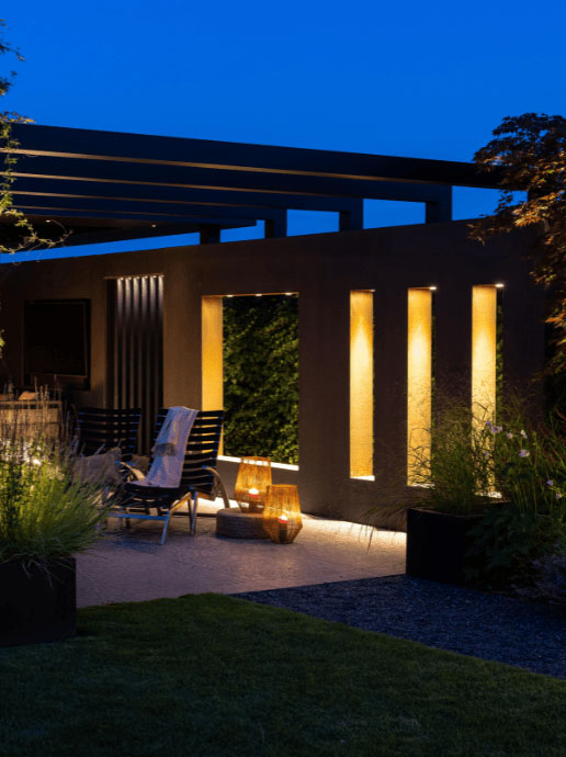 Big Flux asymmetric light illumiunating garden wall