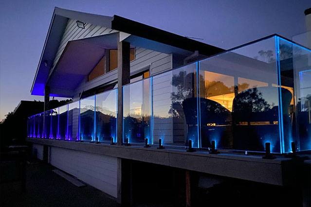 blue lit, illuminated glass railing by LG railing