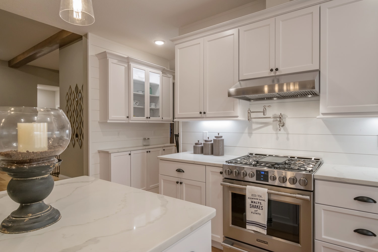 Shiplap wall and shiplap backsplash complement this kitchen nicely